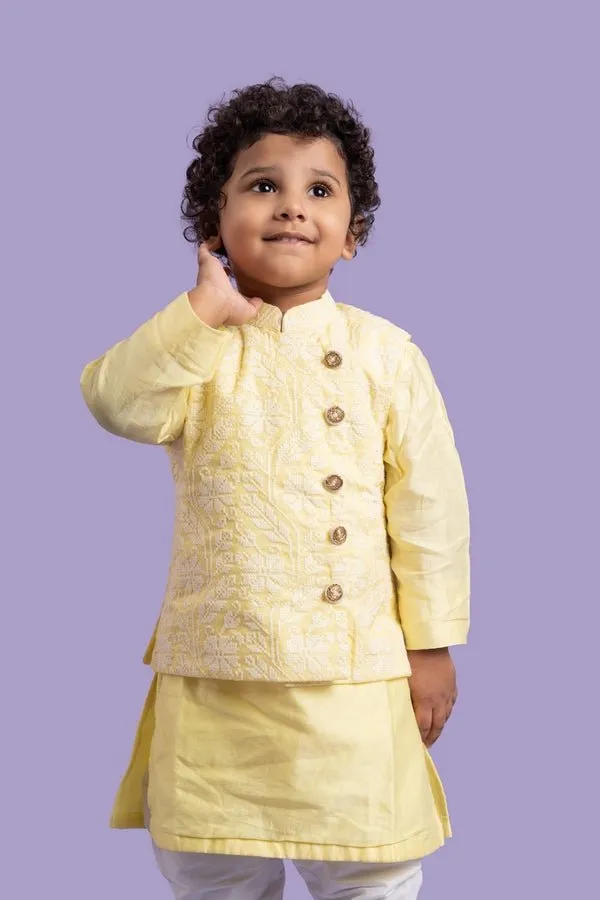 Elegant soft yellow kurta with intricate white embroidery, paired with classic white churidar pants for a timeless festive look