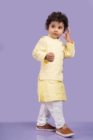 Elegant soft yellow kurta with intricate white embroidery, paired with classic white churidar pants for a timeless festive look